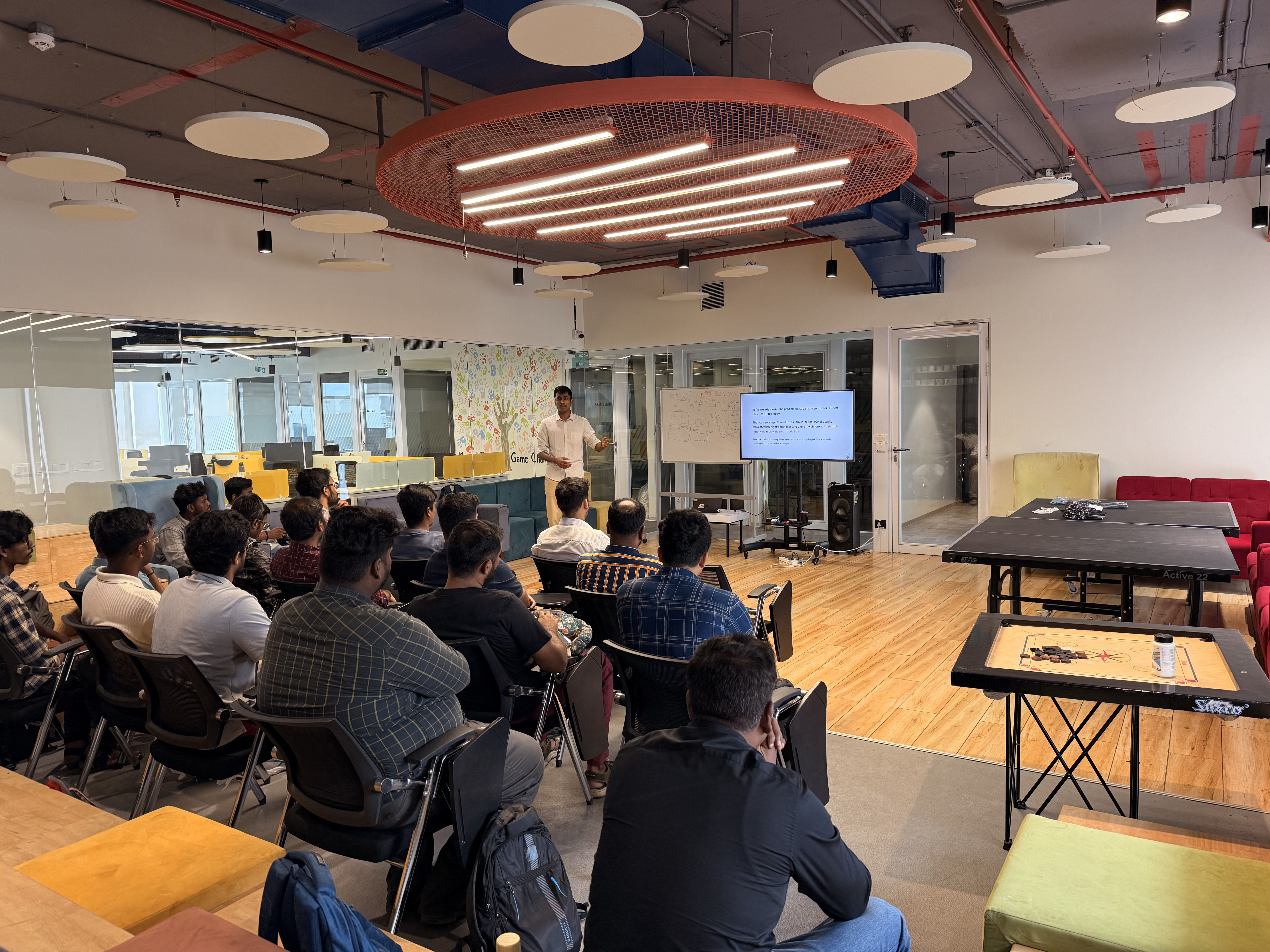 Srihari presenting the CocoIndex talk to a seated audience at the meetup