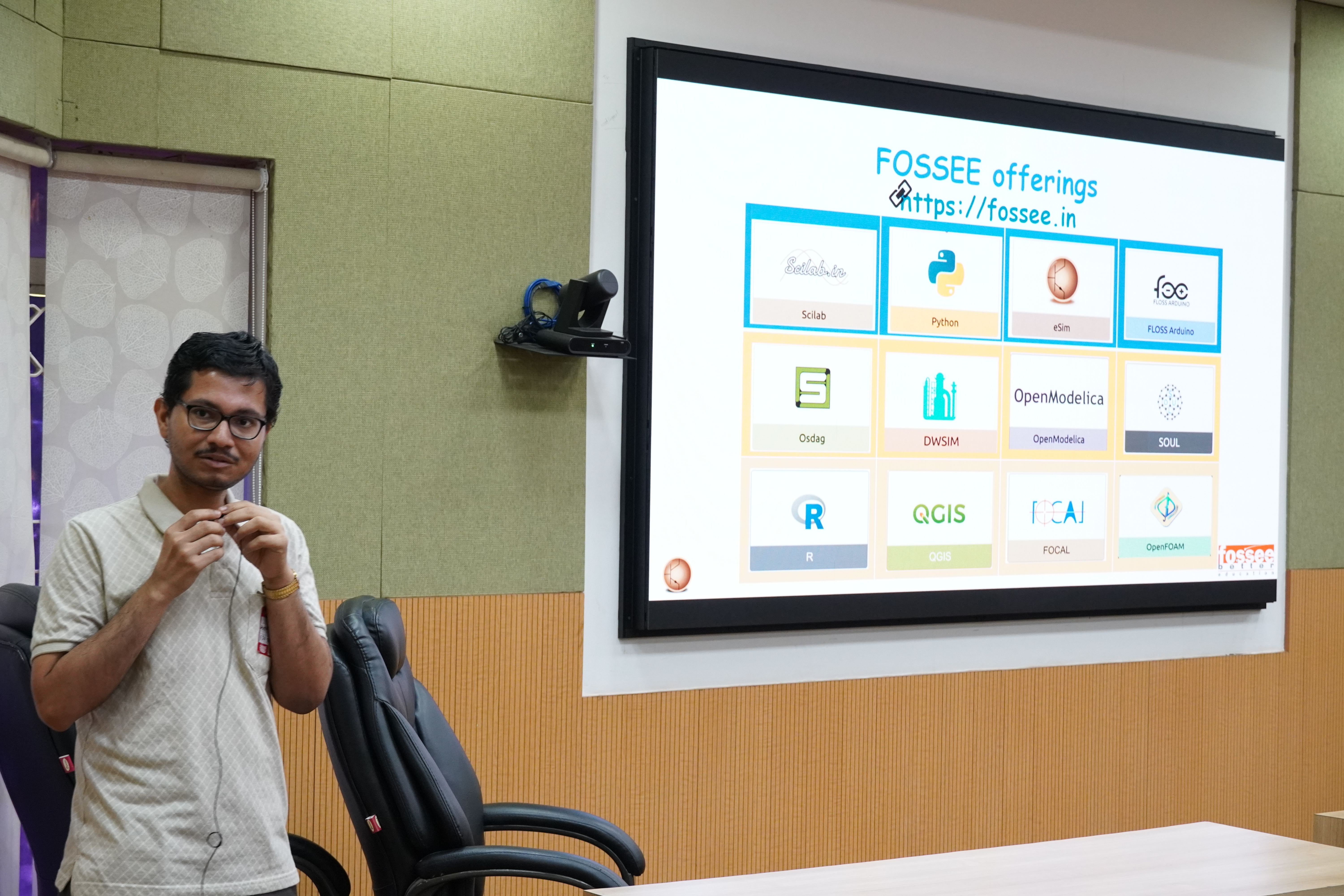 A speaker presenting FOSSEE offerings on a projection screen during ChennaiFOSS 2026