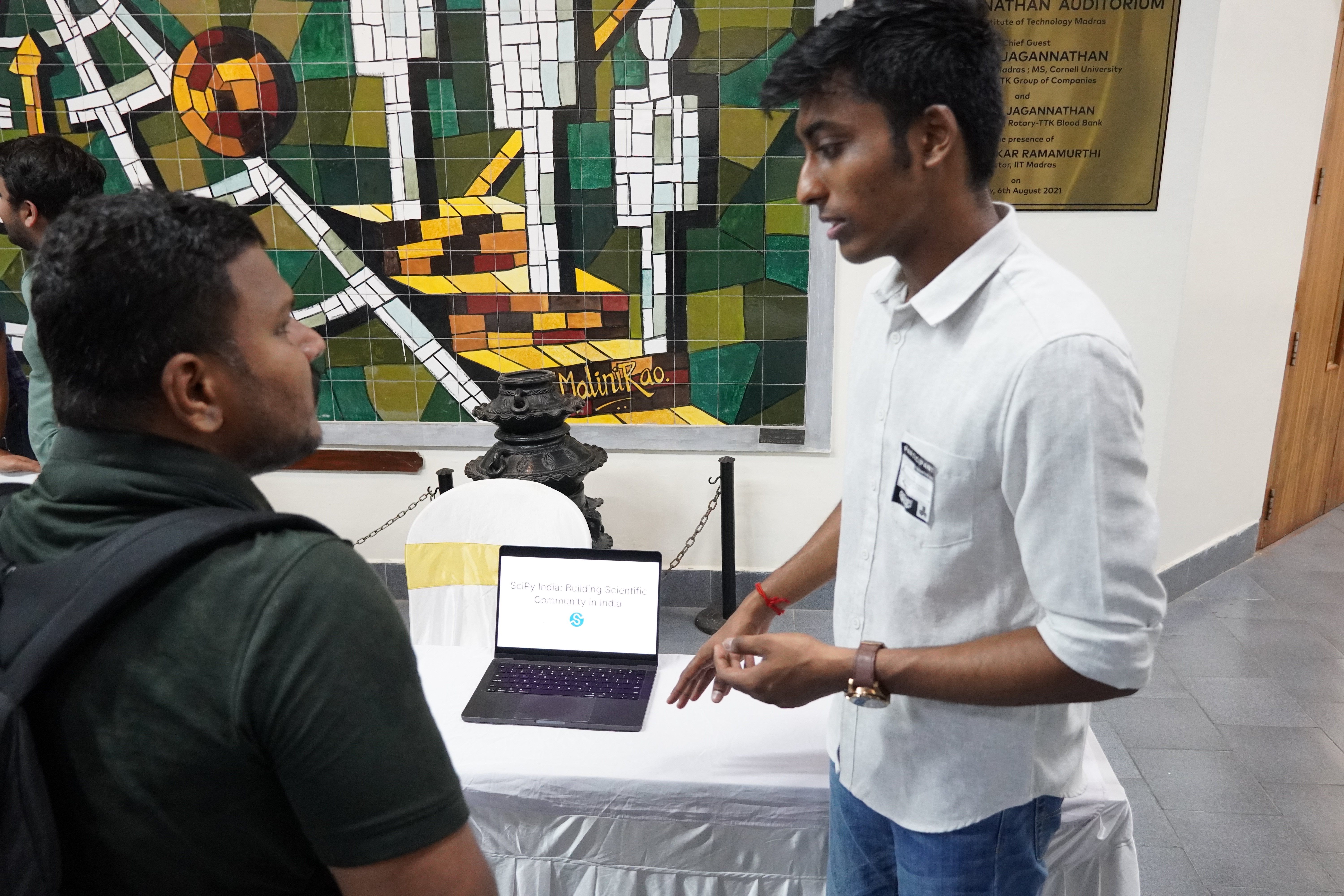 Talking to an attendee at the SciPy India booth during ChennaiFOSS 2026