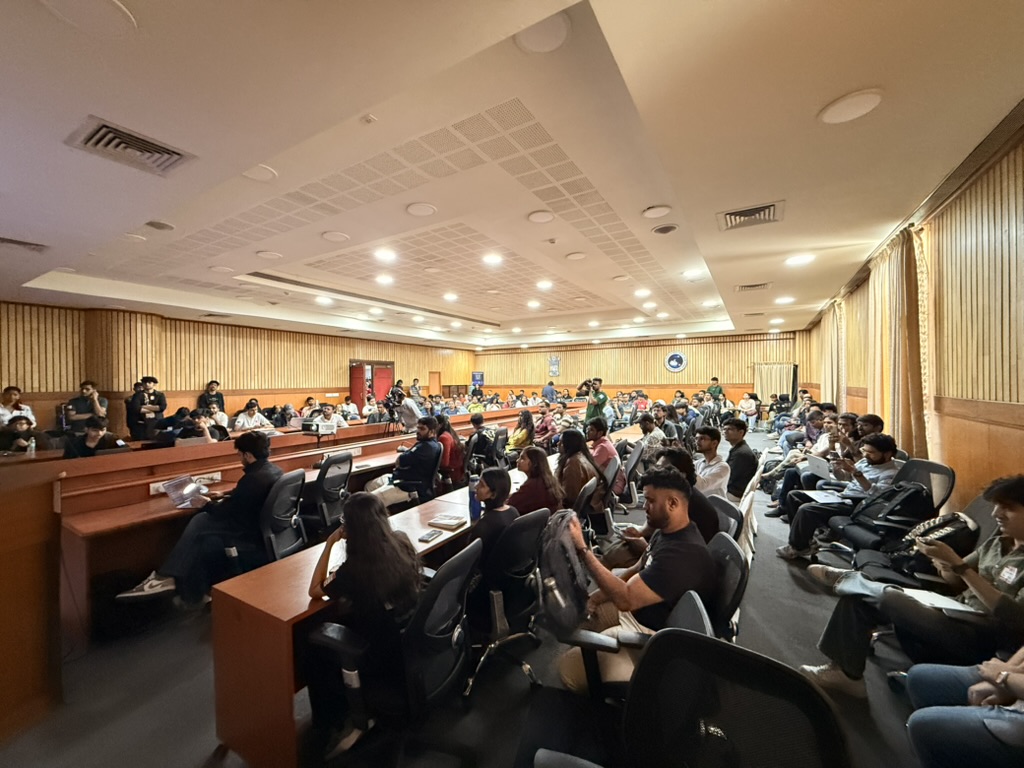 A full room of attendees seated at long desks in the Documentation and Technical Writing devroom at IndiaFOSS 2026