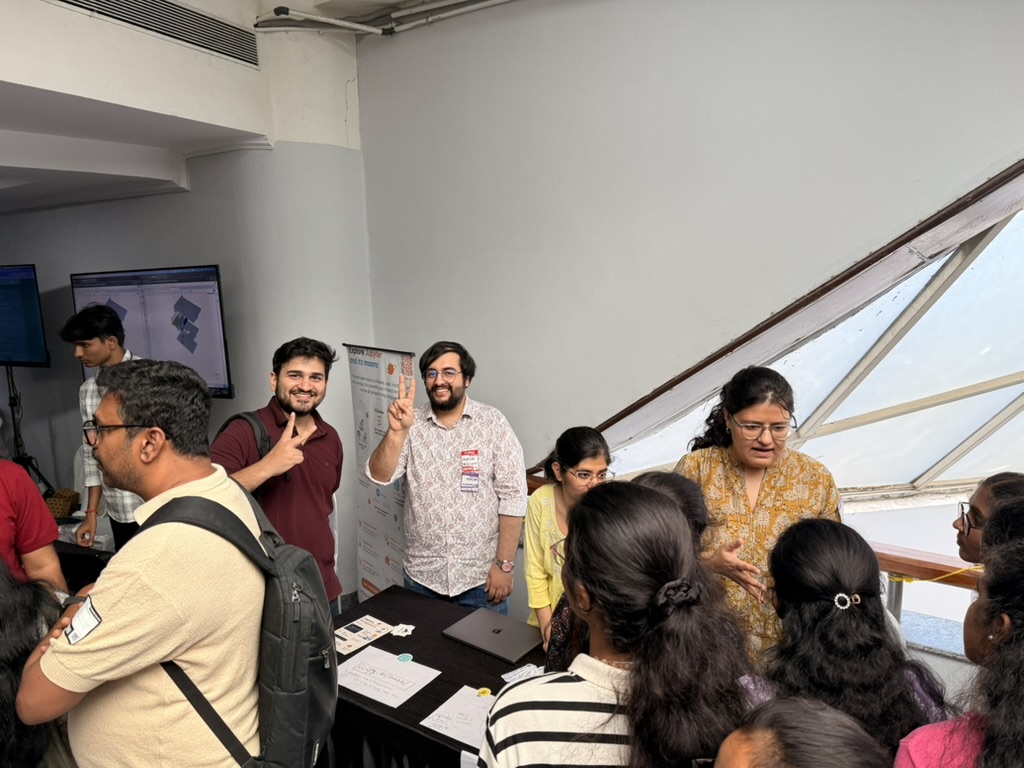Attendees gathered around the SciPy India booth talking to the team