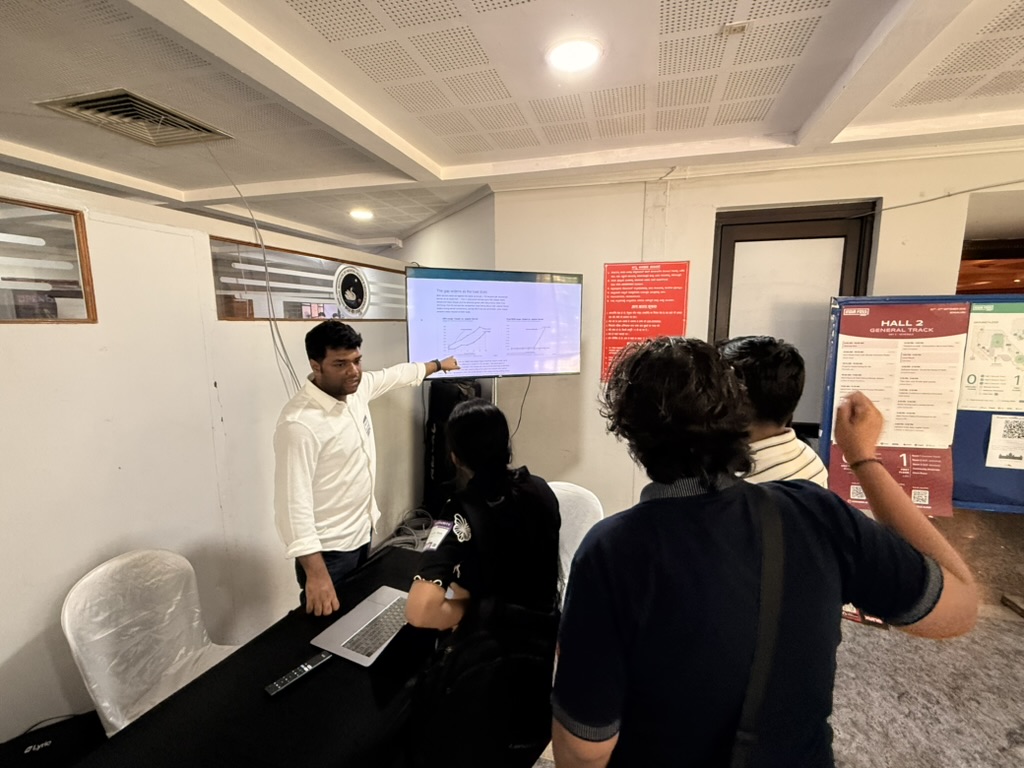 Prasun Anand pointing at a screen while talking to attendees at the Zasper booth